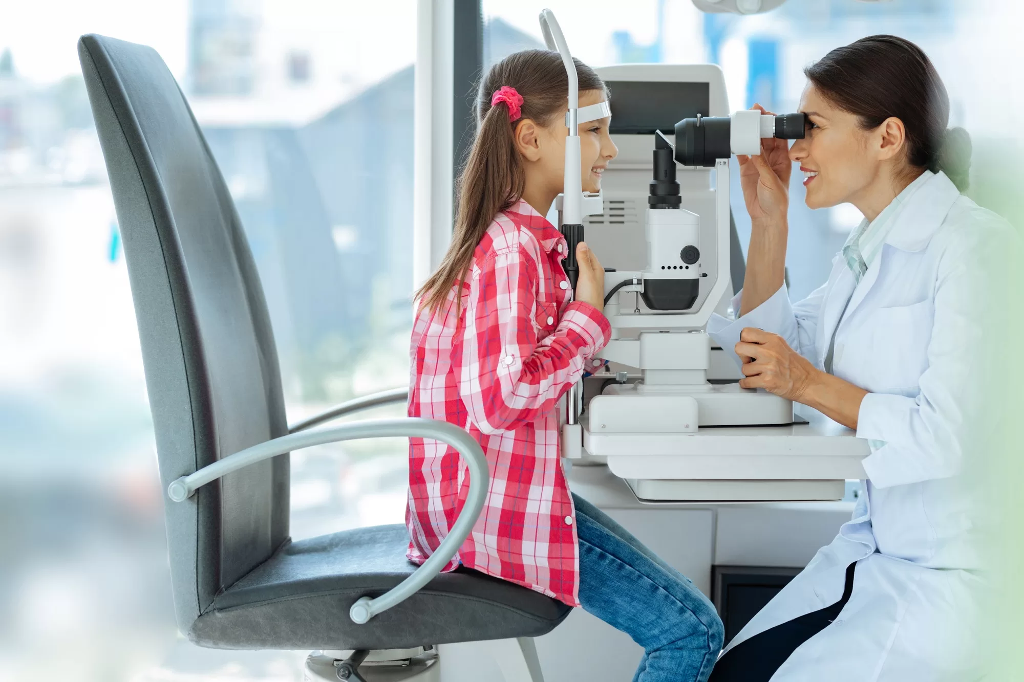 Nice professional doctor checking the girls eyesight